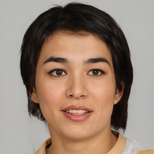 Joyful asian young-adult female with medium  brown hair and brown eyes