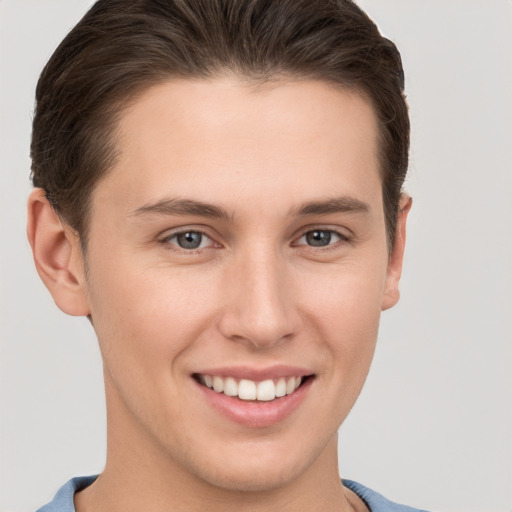 Joyful white young-adult female with short  brown hair and grey eyes