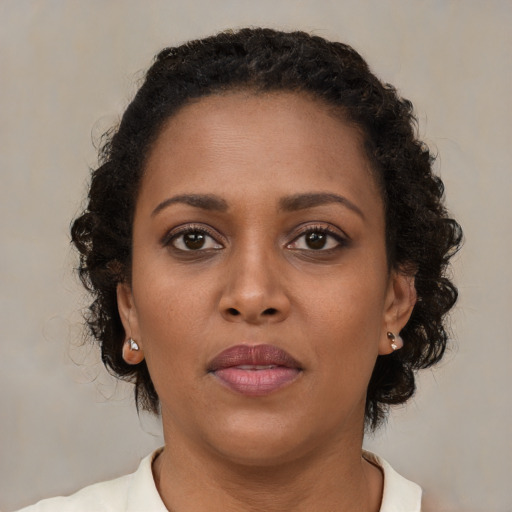 Neutral black young-adult female with medium  brown hair and brown eyes