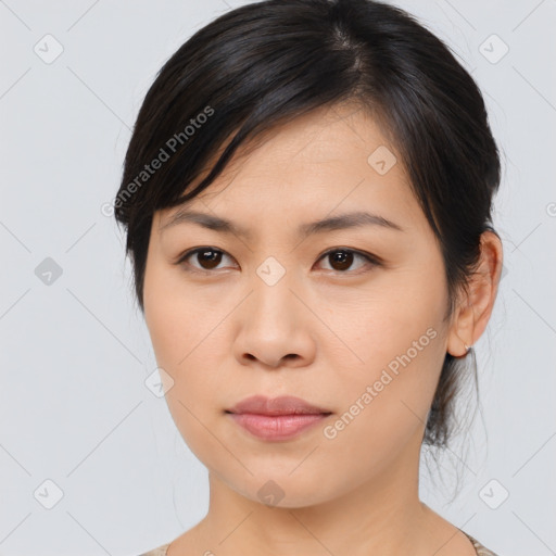 Joyful asian young-adult female with medium  brown hair and brown eyes