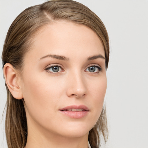 Joyful white young-adult female with long  brown hair and blue eyes