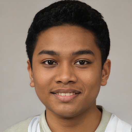 Joyful latino young-adult male with short  black hair and brown eyes