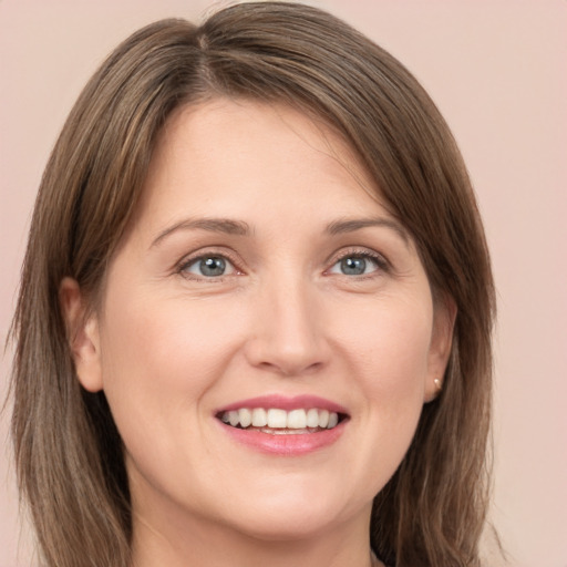 Joyful white young-adult female with medium  brown hair and grey eyes