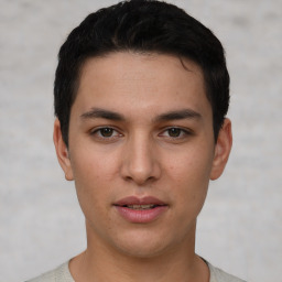 Joyful white young-adult male with short  black hair and brown eyes