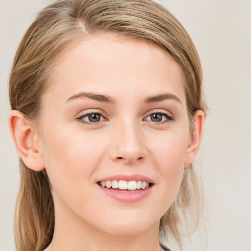 Joyful white young-adult female with medium  brown hair and blue eyes