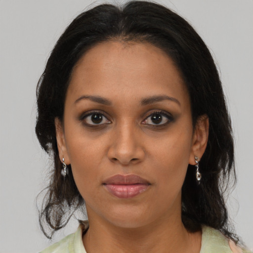 Joyful black young-adult female with medium  brown hair and brown eyes