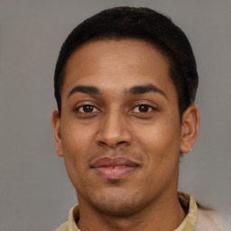 Joyful latino young-adult male with short  brown hair and brown eyes