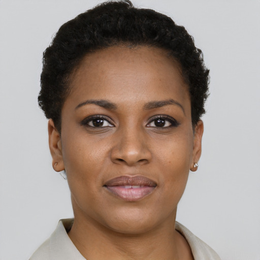Joyful black young-adult female with short  brown hair and brown eyes