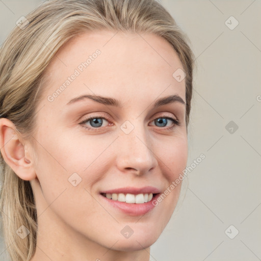 Joyful white young-adult female with long  brown hair and blue eyes