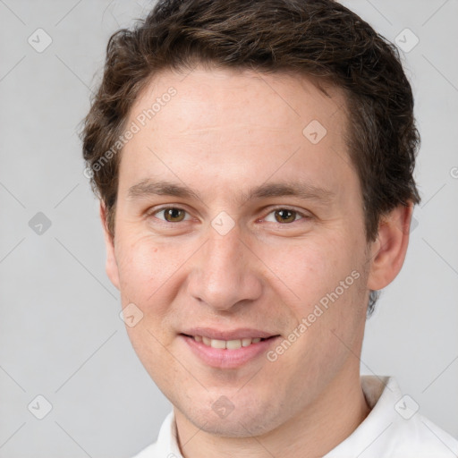 Joyful white adult male with short  brown hair and grey eyes