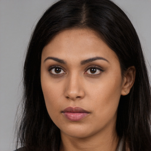 Neutral latino young-adult female with long  brown hair and brown eyes