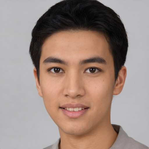 Joyful asian young-adult male with short  black hair and brown eyes