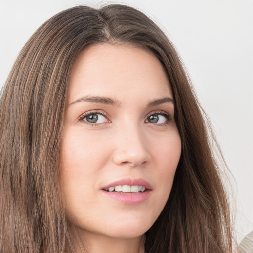 Joyful white young-adult female with long  brown hair and grey eyes