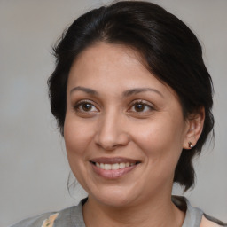 Joyful white adult female with medium  brown hair and brown eyes