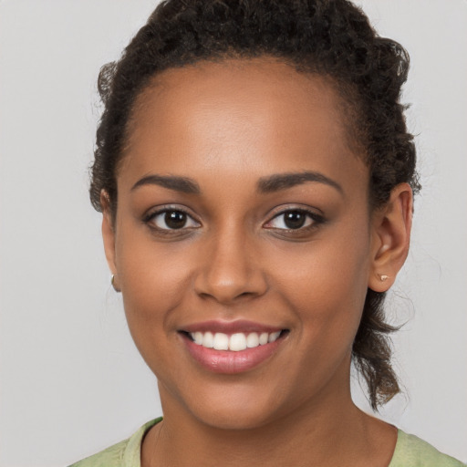 Joyful latino young-adult female with short  brown hair and brown eyes