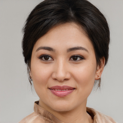 Joyful asian young-adult female with medium  brown hair and brown eyes