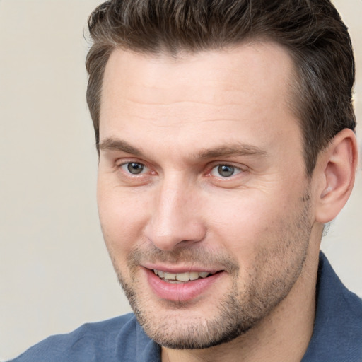 Joyful white adult male with short  brown hair and brown eyes