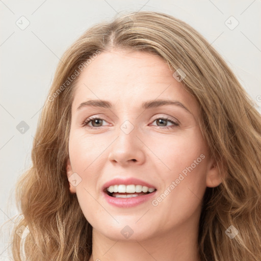 Joyful white young-adult female with long  brown hair and blue eyes