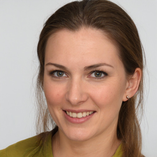 Joyful white young-adult female with medium  brown hair and grey eyes