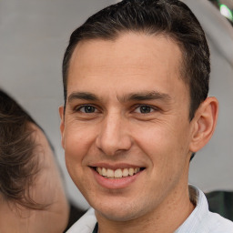 Joyful white adult male with short  brown hair and brown eyes