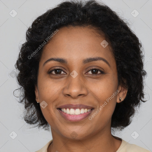 Joyful black young-adult female with long  brown hair and brown eyes