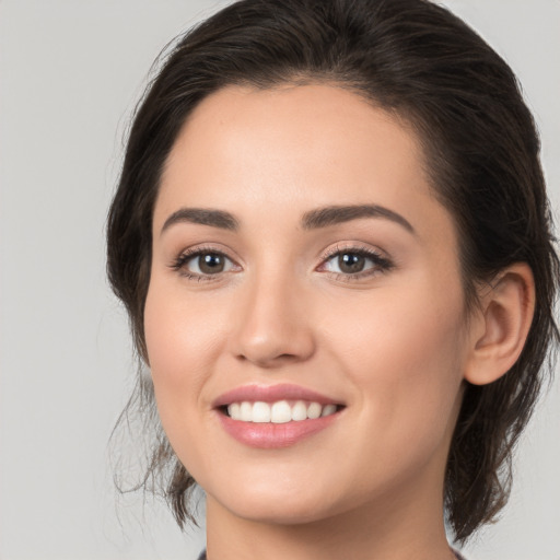 Joyful white young-adult female with medium  brown hair and brown eyes