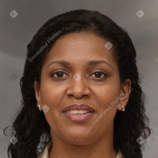 Joyful black adult female with long  brown hair and brown eyes