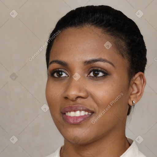 Joyful black young-adult female with short  black hair and brown eyes