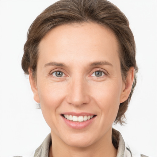 Joyful white adult female with medium  brown hair and grey eyes