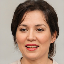 Joyful white adult female with medium  brown hair and brown eyes