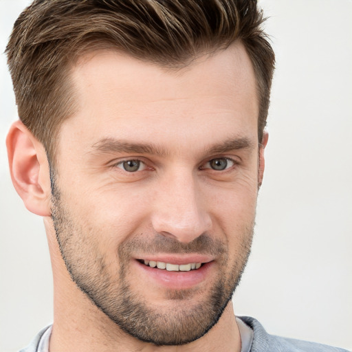 Joyful white young-adult male with short  brown hair and brown eyes