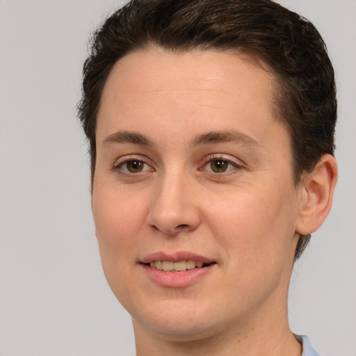 Joyful white young-adult female with short  brown hair and green eyes