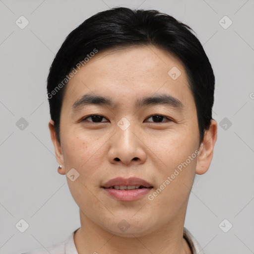 Joyful asian young-adult male with short  black hair and brown eyes