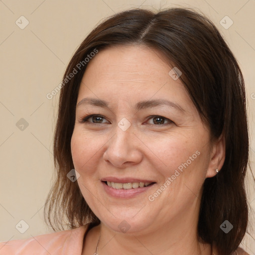 Joyful white adult female with medium  brown hair and brown eyes