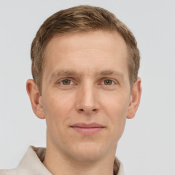 Joyful white adult male with short  brown hair and grey eyes