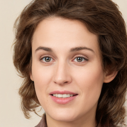 Joyful white young-adult female with medium  brown hair and green eyes