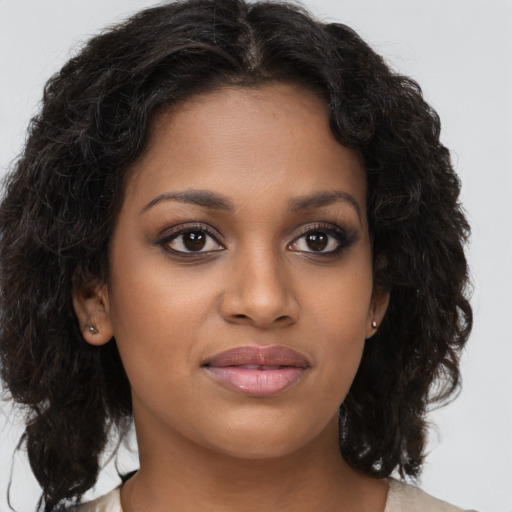 Joyful black young-adult female with medium  brown hair and brown eyes