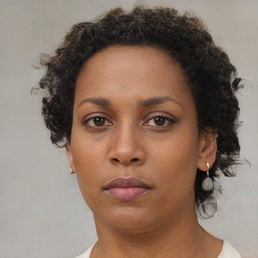 Neutral black adult female with short  brown hair and brown eyes