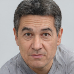 Joyful white middle-aged male with short  brown hair and brown eyes