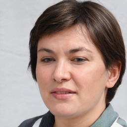 Joyful white adult female with medium  brown hair and brown eyes