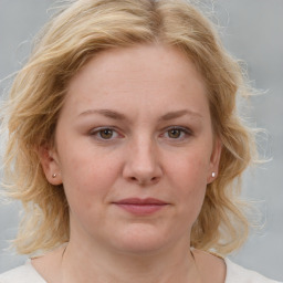 Joyful white young-adult female with medium  brown hair and blue eyes