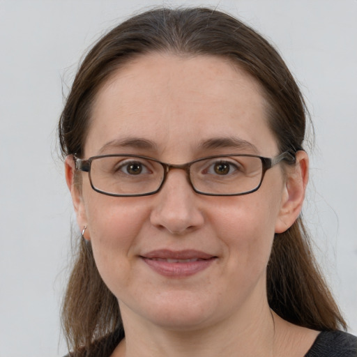 Joyful white adult female with medium  brown hair and grey eyes