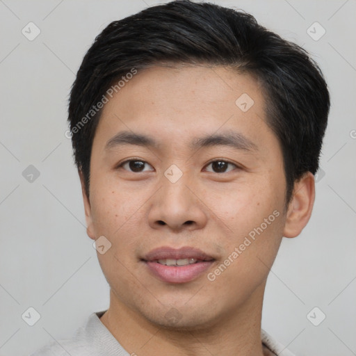 Joyful asian young-adult male with short  black hair and brown eyes