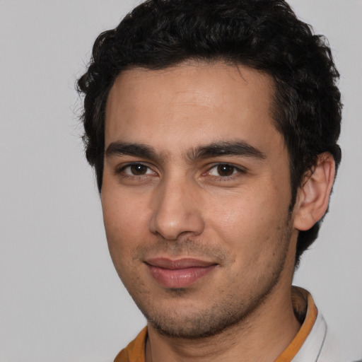 Joyful white young-adult male with short  black hair and brown eyes