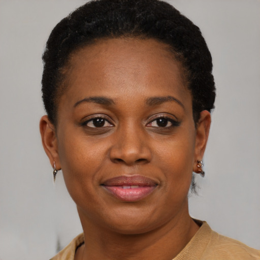 Joyful black young-adult female with short  brown hair and brown eyes