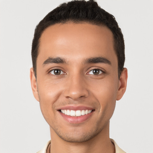 Joyful white young-adult male with short  black hair and brown eyes