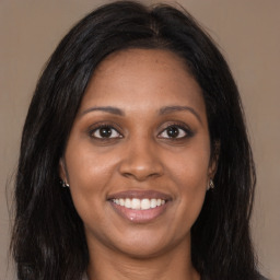 Joyful latino young-adult female with long  brown hair and brown eyes