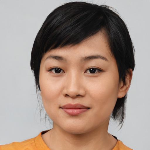 Joyful asian young-adult female with medium  black hair and brown eyes