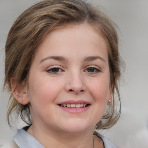 Joyful white child female with medium  brown hair and grey eyes