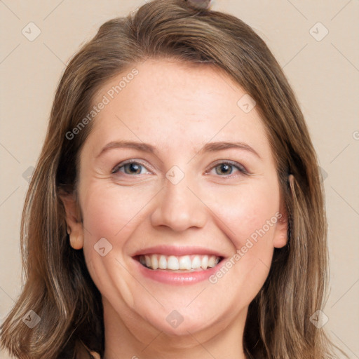 Joyful white adult female with long  brown hair and grey eyes